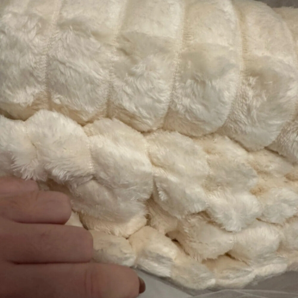 Close-up of a soft white MoraNest blanket