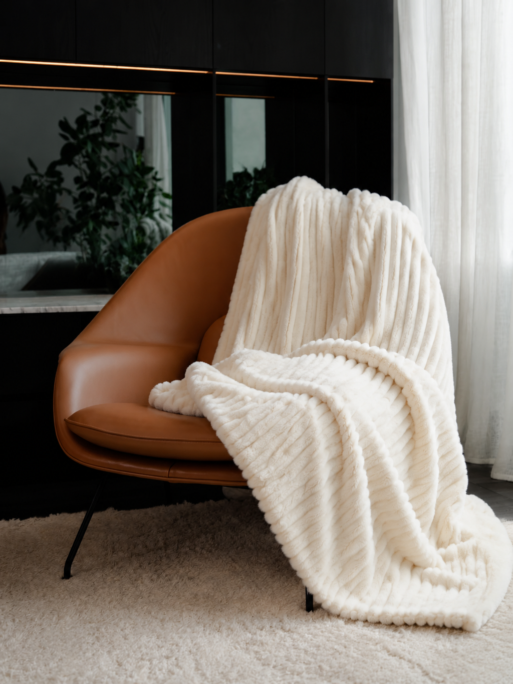 18. MoraNest Milky White blanket - woman wrapped on sofa